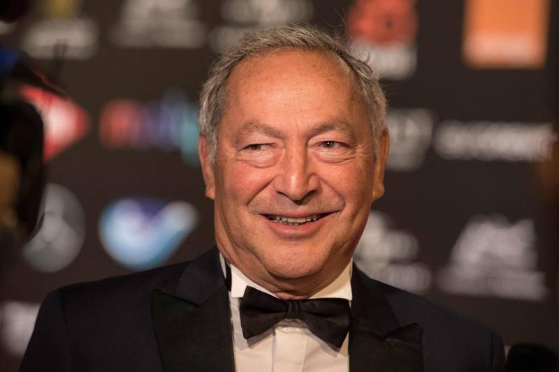Egyptian billionaire businessman and co-founder of the Elgouna Film Festival Samih Sawiris poses on the red carpet during the closing session of the 5th edition of the Gouna Film Festival in Egypt's Red Sea resort of el-Gouna on October 22, 2021.  (Photo by Khaled DESOUKI  /  AFP)