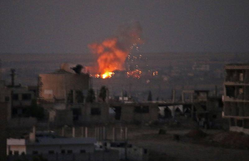 TOPSHOT - This picture shows an explosion in rebel-held areas of the city of Daraa during reported airstrikes by Syrian regime forces on July 5, 2018. Waves of air strikes pounded rebel-held areas of southern Syria after the failure a day earlier of Russian-brokered talks to end the offensive in Daraa province, which has killed dozens and forced tens of thousands from their homes. / AFP / MOHAMAD ABAZEED
