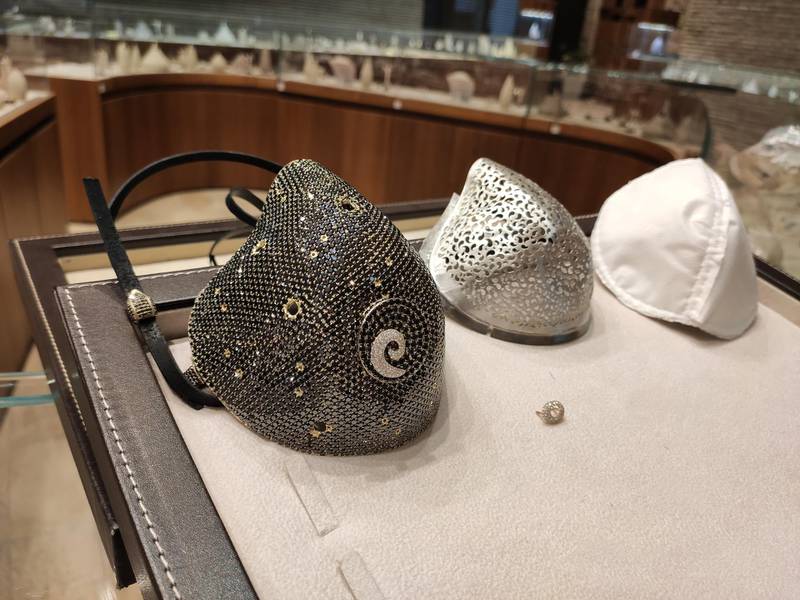 The face mask and its different layers. The outer, diamond cover layer; the filigree gold inner layer, and the removable N99 filter. Courtesy Yvel