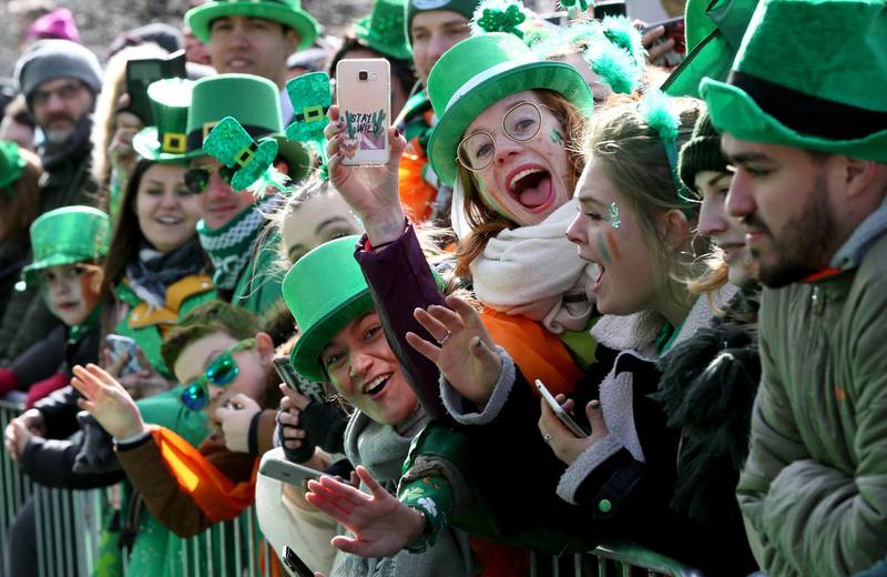 Spectators line the route during the annual St Patricks Day parade through the city centre of Dublin on March 17, 2019. (Photo by Paul FAITH / AFP)