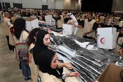 Volunteers packing Emirates Red Crescent aid boxes for the affected people by earthquakes in Syria and Turkey. Pawan Singh / The National