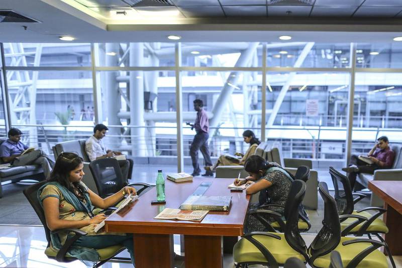 Employees sit working in the library of the Tata Consultancy Services campus in the State Industries Promotion Corporation of Tamil Nadu IT Park in the Siruseri area of Chennai, India. Dhiraj Singh / Bloomberg