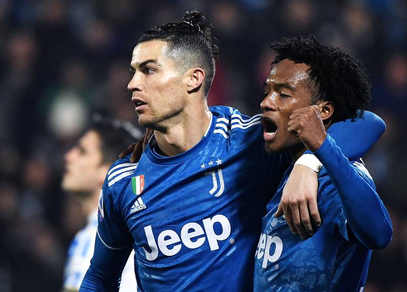 Cristiano Ronaldo celebrates with Colombian midfielder Juan Cuadrado after opening the scoring. AFP