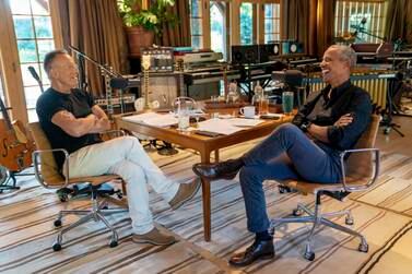 Bruce Springsteen, left, appears with former President Barack Obama during their podcast of conversations recorded at Springsteen's home studio in New Jersey. The eight-episode series covers their upbringings, racism, fatherhood and even recall a White House singalong around a piano. (Rob DeMartin/Spotify via AP)