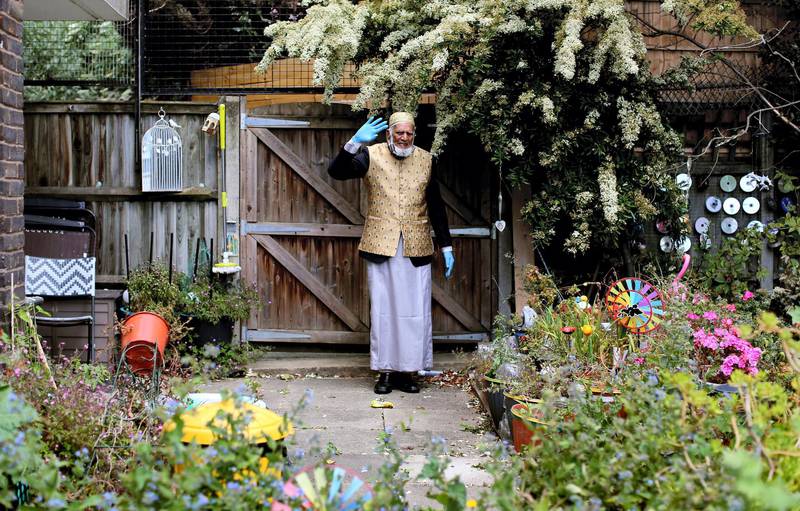 LONDON, UNITED KINGDOM - MAY 23: 100-year-old Dabirul Islam Choudhury walks laps of his communal garden in Bow, east London, United Kingdom on May 23, 2020, while still fasting during Ramadan as he is raising money for the Ramadan Family Commitment (RFC) Covid-19 Crisis Initiative, which funds will be distributed for those affected by the virus in the UK and Bangladesh. Inspired by British Second World War veteran Captain Tom Moore, the 100-year-old began walking 100 laps of the 80-metre garden on April 26 to raise Ã‚Â£1,000. Today funds has reached over Ã‚Â£200,000 (over $243,000). (Photo by Isabel Infantes /Anadolu Agency via Getty Images)