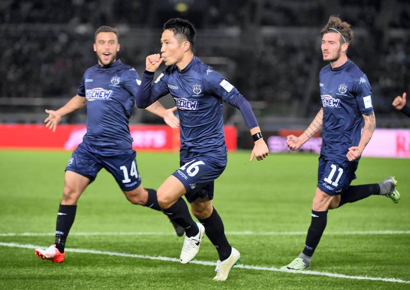 Auckland City defender Kim Daewook reacts after scoring with his teammates Fabrizio Tavano (R) and Clayton Lewis (L) during the Club World Cup football match between Auckland City and the Kashima Antlers in Yokohama on December 8, 2016. / AFP PHOTO / Toru YAMANAKA