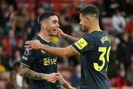Newcastle United's Miguel Almiron celebrates with Bruno Guimaraes after scoring the team's sixth goal against Sheffield United. Getty