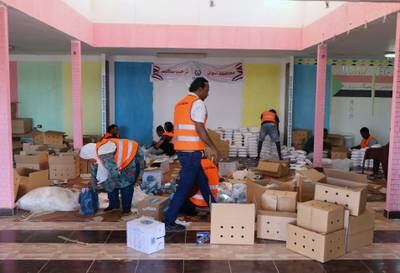 Volunteers prepare aid packages for people who fled the fighting in Sudan, at Wadi Karkar bus station in Aswan, Egypt. EPA