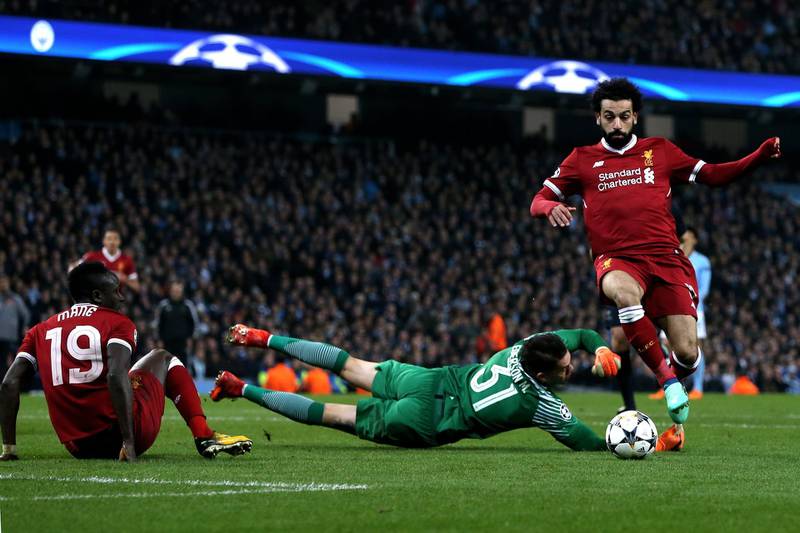 Liverpool's Mohamed Salah dribbles around Manchester City goalkepper Ederson to score his side's first goal. Nigel Roddis / EPA