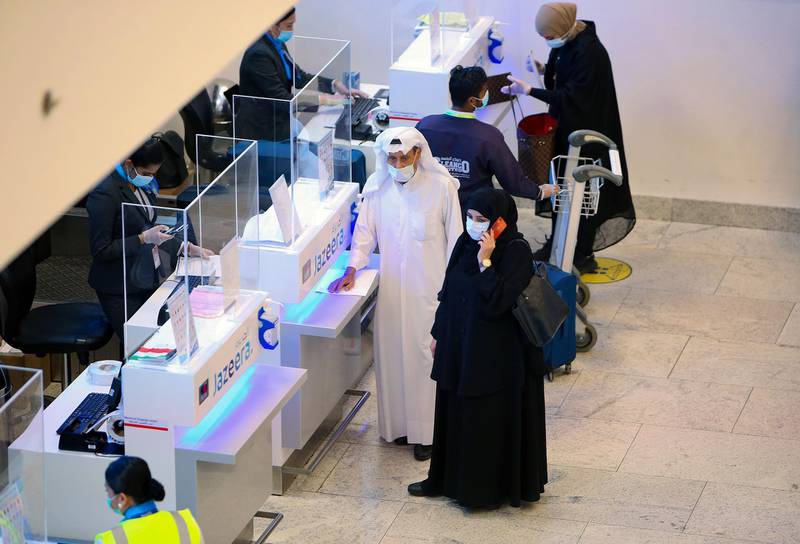 Travellers wait at s registering counter at Kuwait international Airport. AFP