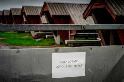 A sign in Danish language reads "No access - risk of Covid-19 infection" at a minks farm in Hjorring, in North Jutland, Denmark. AFP