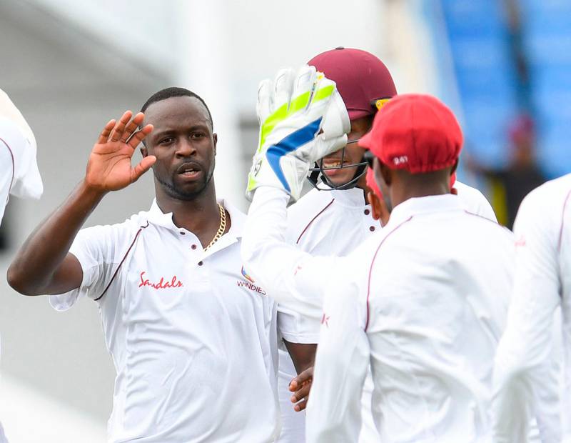 Kemar Roach (L) of West Indies celebrates the dismissal of Shakib Al Hasan of Bangladesh during day 1 of the 1st Test between West Indies and Bangladesh at Sir Vivian Richards Cricket Ground, North Sound, Antigua, on July 4, 2018. / AFP / Randy Brooks
