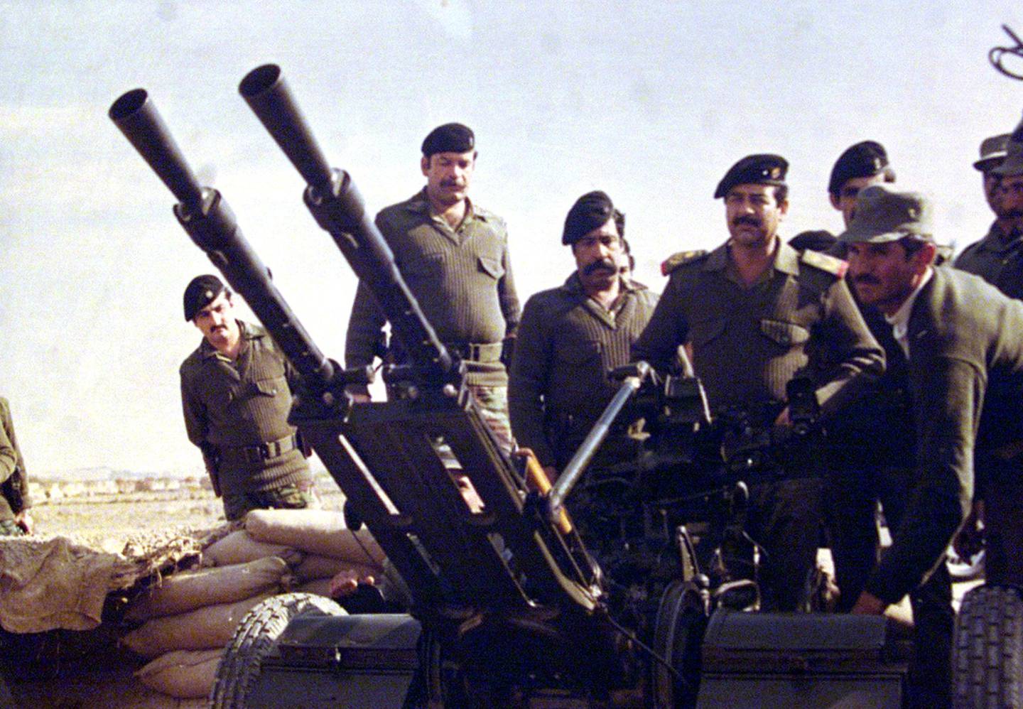 (FILES)--In this photograph made available by the official Iraqi presidential photographer 26 April 2002, Iraqi President Saddam Hussein is seen at the Iraq-Iran border during Iraq-Iran war 1980-1988. Saddam will celebrate his 65th birthday on 28 April. He was born in 1937 in Takrit, in the province of Salahedin, 170 kms north of Baghdad. AFP PHOTO/HO (Photo by PRESIDENTIAL PALACE / AFP)