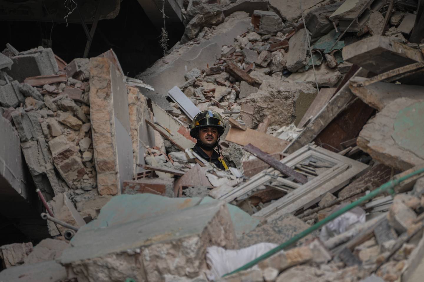 A rescuer looks out from rubble of the five-star Hotel Saratoga in Havana, Cuba.  AP Photo