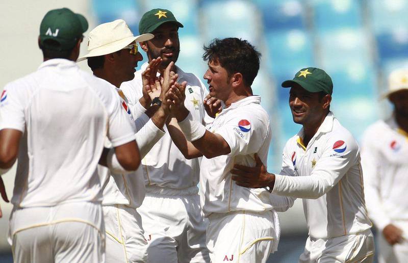 Pakistan has raised the possibility that it may not travel to the World Twenty20 in India next year. On Saturday, bowler Yasir Shah, center right, and his teammates were up against England on Day 3 of their second Test series at the Dubai International Stadium. (AP Photo)