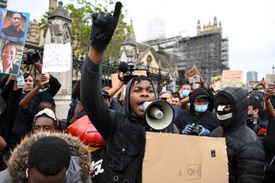 British actor John Boyega speaks to protestors in Parliament square during an anti-racism demonstration in London.  AFP