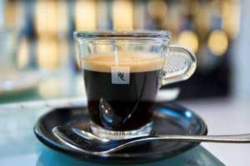 epa01821350 (FILE) A file picture dated on 16 March 2003 shows a cup of coffee in a Nespresso-Shop in Geneva, Switzerland. Nestle SA, the world's biggest food and drink maker, reported on 12 August 2009 that a two per cent fall in first-half net profit as divestments and the strength of the Swiss franc weighed on sales.  EPA/MARTIN RUETSCHI DATABASE, NO SALES, NO ARCHIVES *** Local Caption ***  01821350.jpg *** Local Caption ***  01821350.jpg *** Local Caption ***  01821350.jpg