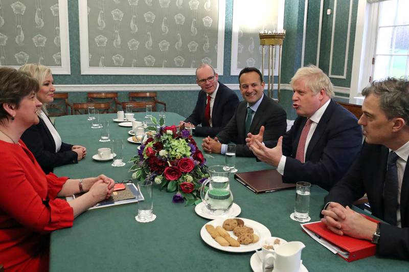 Deputy First Minister Michelle O'Neill of Sinn Fein, First Minister Arlene Foster of the DUP sit around the table with Deputy Prime Minister of Ireland, Simon Coveney, Irish Taoiseach (Prime Minister) Leo Varadkar, Secretary of State for Northern Ireland Julian Smith and Britain's Prime Minister Boris Johnson in the Great Hall in the Stormont Parliament Buildings in Belfast, Northern Ireland, January 13, 2020. Liam McBurney/Pool via REUTERS