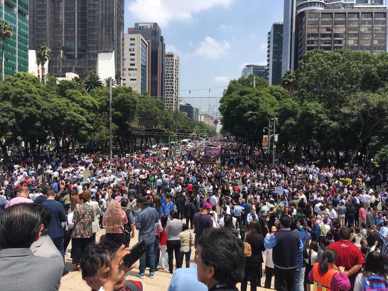People fill Paseo de la Reforma after evacuating from their offices after an earthquake in Mexico City. A powerful earthquake has jolted Mexico, causing buildings to sway sickeningly in the capital on the anniversary of a 1985 quake that did major damage. Anita Baca / AP Photo