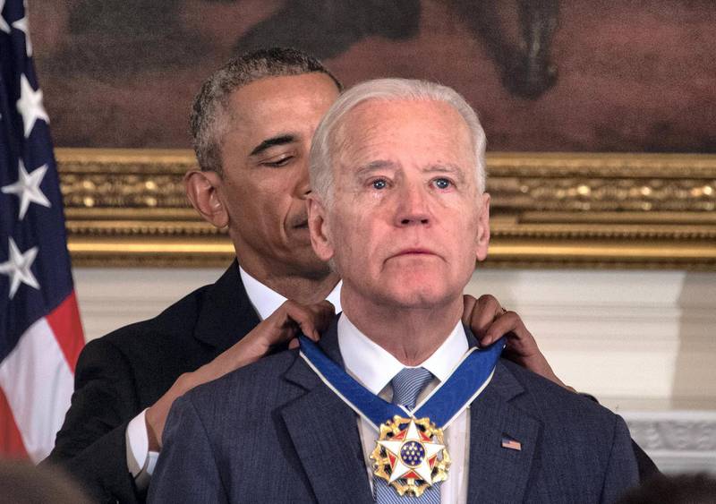 (FILES) In this file photo taken on January 12, 2017 US President Barack Obama awards Vice President Joe Biden the Presidential Medal of Freedom during a tribute to Biden at the White House in Washington, DC. - He has suffered profound personal tragedy and seen his earlier political ambitions thwarted, but veteran Democrat Joe Biden hopes his pledge to unify Americans will deliver him the presidency after nearly half a century in Washington (Photo by NICHOLAS KAMM / AFP)