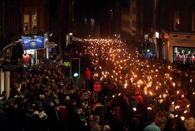 Members of the public take part during the torchlight procession on Edinburgh's Royal Mile for the start of the Hogmanay celebrations. PA/AP