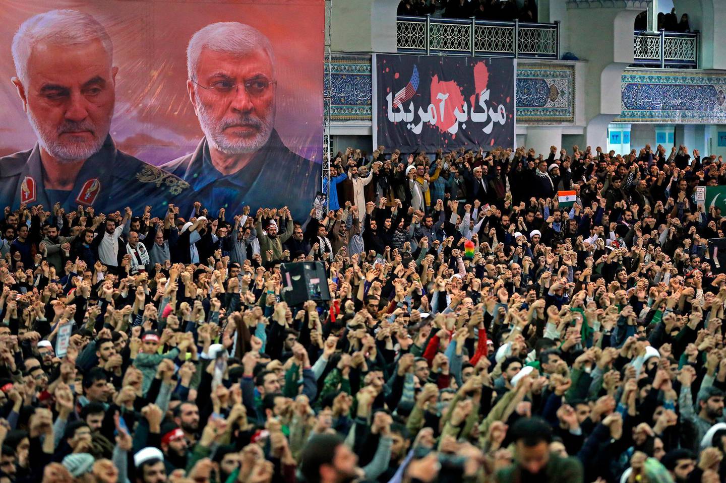 FILE - In this Jan. 17, 2020 file photo, released by the official website of the office of the Iranian supreme leader, worshippers chant slogans during Friday prayers ceremony, as a banner show Iranian Revolutionary Guard Gen. Qassem Soleimani, left, and Iraqi Shiite senior militia commander Abu Mahdi al-Muhandis, who were killed in Iraq in a U.S. drone attack on Jan. 3, and a banner which reads in Persian: "Death To America, "at Imam Khomeini Grand Mosque in Tehran, Iran. On Thursday, Jan. 7, 2021, Iraqâ€™s judiciary issued an arrest warrant for outgoing U.S. President Donald Trump in connection with the killing of Soleimani and a al-Muhandis last year. The warrant was issued by a judge in Baghdadâ€™s investigative court tasked with probing the Washington-directed drone strike, the courtâ€™s media office said. (Office of the Iranian Supreme Leader via AP, File)