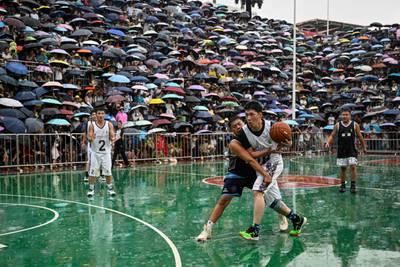 Players vie for points during an invitational game of the grassroots basketball competition CunBA in Taipan village, Taijiang county, in southwestern China's Guizhou province. AFP