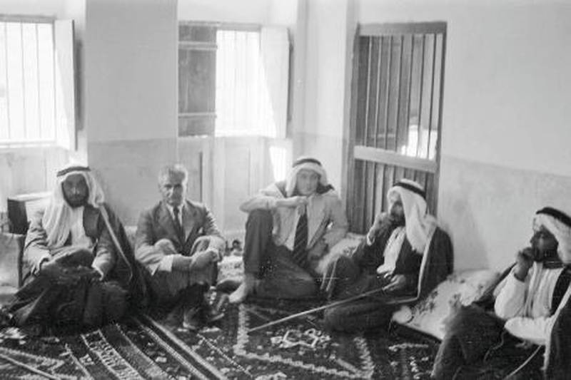Abu Dhabi, Trucial Oman States . 1957 (date to be confimed)  Photograph shows Roddy Owen (third from right) sitting in the upstairs majlis at Qasr Al Hosn Fort. (The other western gentleman is unidentified) On the Far left is Sheikh Zayed Al Nahyan. Second right is Sheikh Shakbut Al Nahyan. Man on far right unidentified *** Local Caption *** Eds note. Karen**Permission should be sought prior to any reproduction**  Literary executor contacts:  Charles Harding - hardingholefarm@aol.com Charles Darwent - charlesdarwent@aim.com  Credit: Literary Estate of Roderic Owen