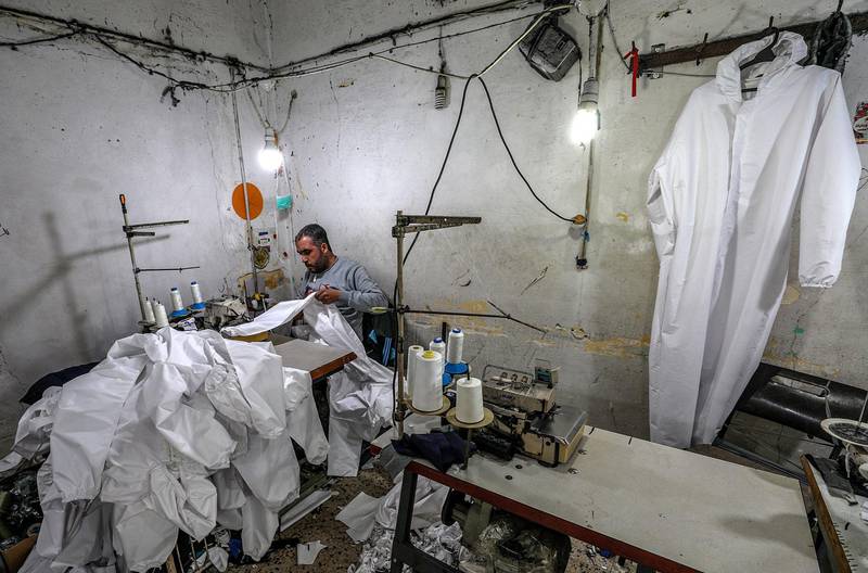 Palestinians manufacture protective coverall suits in a small sewing factory in Gaza City.  EPA