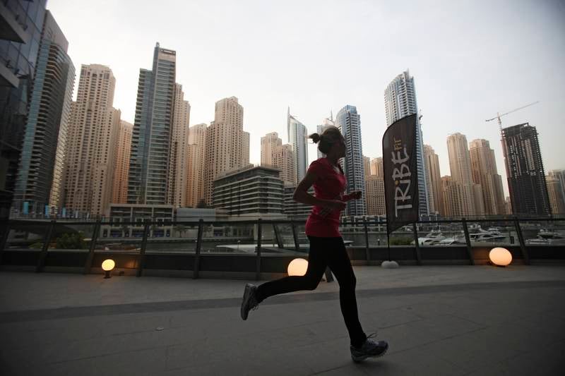 Dubai, UAE, July 9, 2013:

Tribe Fit is a new gym in the Marina. The gym's ethos is to combine physical exercise with social events to create a fit and friendly community. 

A member runs on the terrace of the gym which overlooks JBR. *** Local Caption ***  LH1007_TRIBE_FIT_006.JPG