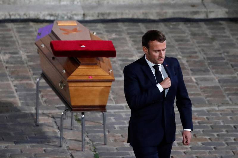 French President Emmanuel Macron leaves after paying his respects by the coffin of slain teacher Samuel Paty in the courtyard of the Sorbonne university during a national memorial event, in Paris, France October 21, 2020. Francois Mori/Pool via REUTERS