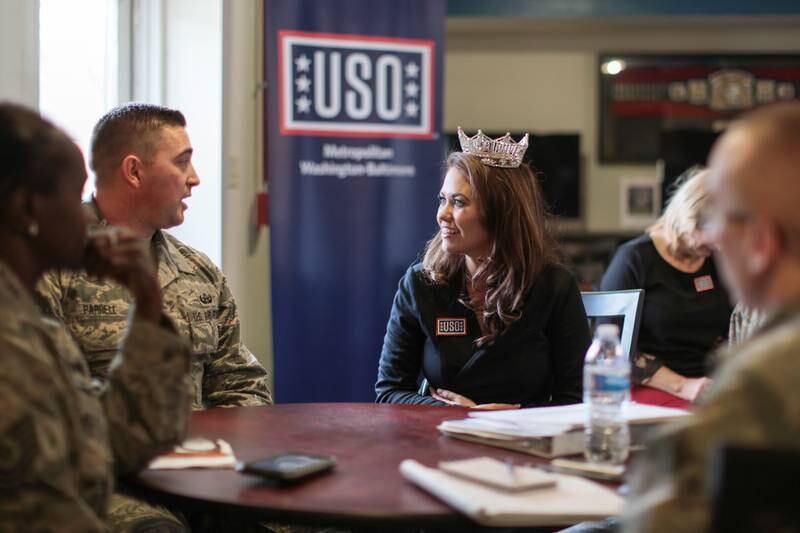 Ms Mund sits with soldiers at Camp Pendleton during her visit to the Fort Meade USO in 2018. Photo: Fort George G Meade Public Affairs Office