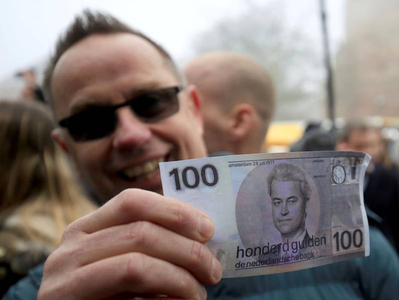 A supporter with a fake 100 guilder note depicting the Dutch rightwing populist and leader of the Partij voor de Vrijheid (Party for Freedom, PVV) Geert Wilders at a meeting of Wilders supporters in Spijkenisse in South Holland, Netherlands, 18 February 2017. Photo by: Oliver Berg/picture-alliance/dpa/AP Images