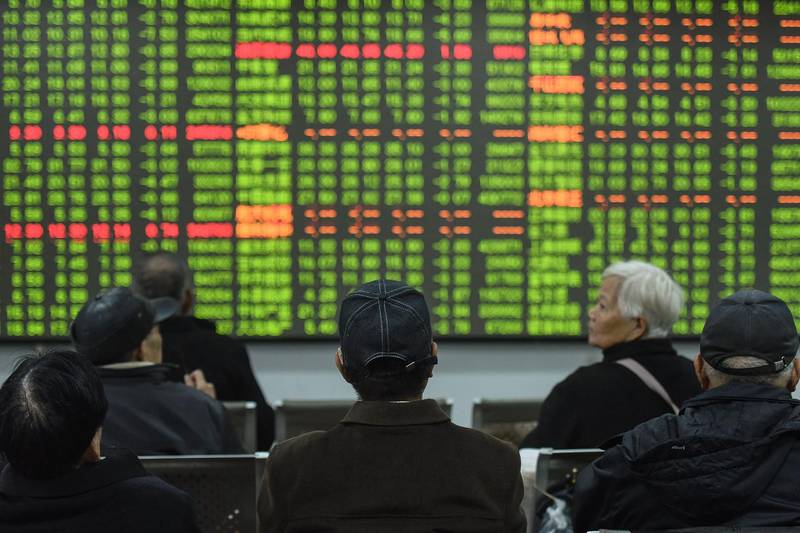 Investors look at a screen showing stock market movements at a securities company in Hangzhou in China's eastern Zhejiang province. Chinese stocks crashed on February 3 with some major shares quickly falling by the maximum daily limit as the country's investors got their first chance in more than a week to react to the spiralling coronavirus outbreak.  AFP