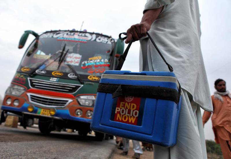 Pakistani healthcare workers wait to administer polio vaccinations to children aboard buses arriving in Karachi city from other provinces. Asim Hafeez for The National