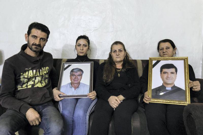 The Bedoyan Family pose with pictures of the late priest and his father. Thibault Lefébure for The National.