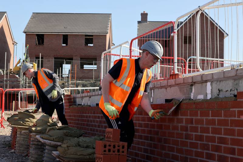 File photo of bricklayers on a Barratt Homes development site. 