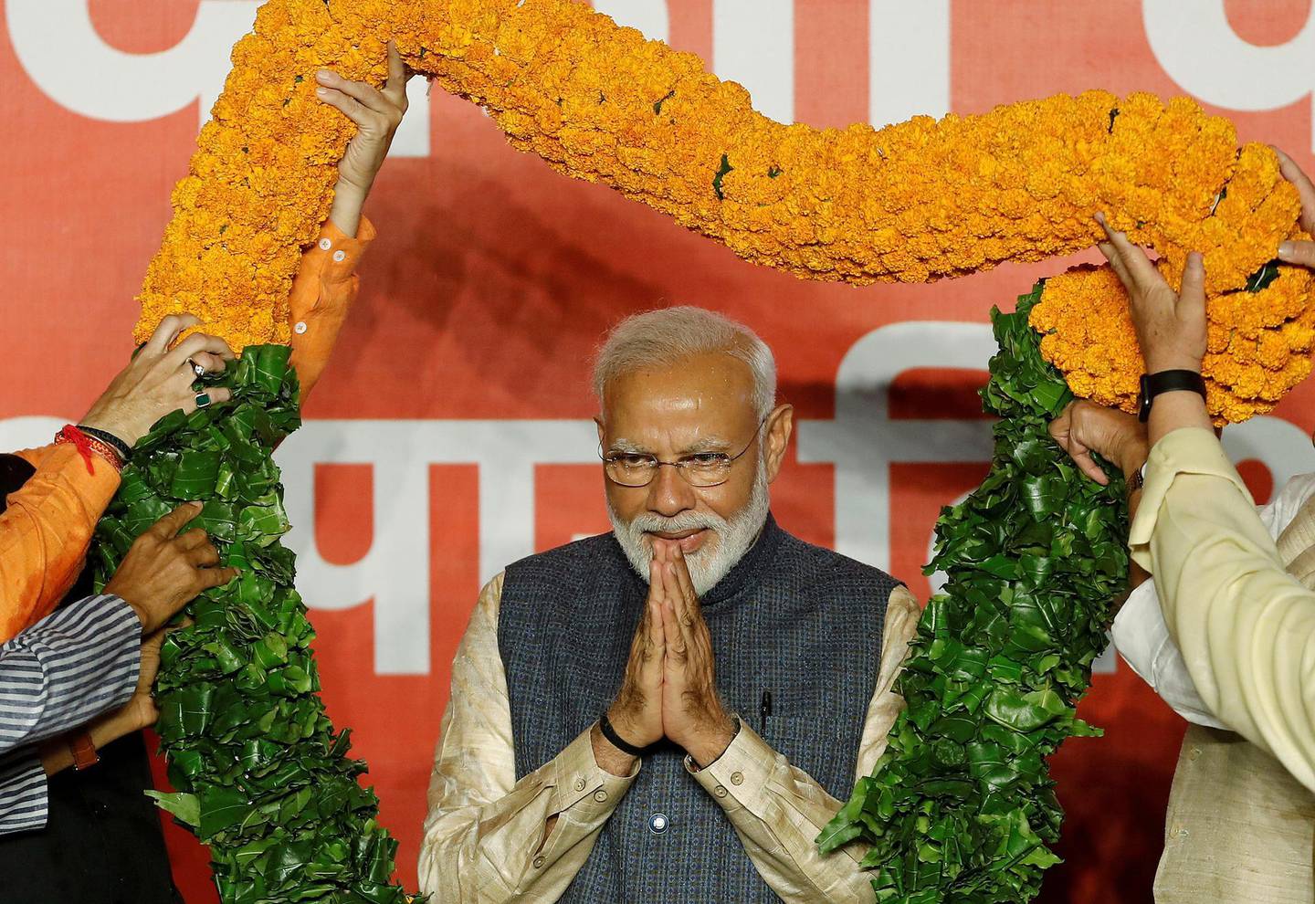 FILE PHOTO: Indian Prime Minister Narendra Modi gestures as he is presented with a garland by Bharatiya Janata Party (BJP) leaders after the election results in New Delhi, India, May 23, 2019. REUTERS/Adnan Abidi/File Photo