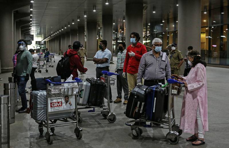 Stranded Indian passengers who arrived by an Air India flight from Singapore wait for transport. EPA