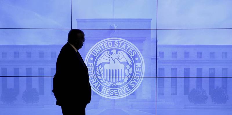 FILE PHOTO: A security guard walks in front of an image of the Federal Reserve before the arrival of U.S. Federal Reserve Chair Janet Yellen to give a news conference following the two-day Federal Open Market Committee (FOMC) policy meeting in Washington, March 16, 2016. REUTERS/Kevin Lamarque/File Photo