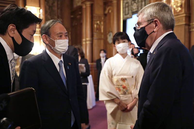 Japanese Prime Minister Yoshihide Suga and IOC President Thomas Bach have been determined to continue with the Olympics despite the Covid-19 pandemic. AP Photo