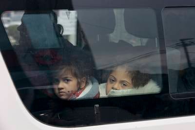 Ethnic Armenian children look through a car window after crossing into Armenia. Thousands are fleeing the Nagorno-Karabakh enclave following Azerbaijan's military victory.  AP Photo