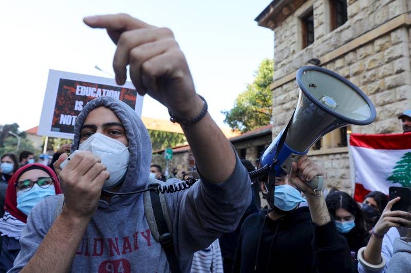 Protesters chant slogans during a demonstration outside the American University of Beirut. They object to a decision by some universities to adopt a new dollar exchange rate to set the price of tuition. AFP