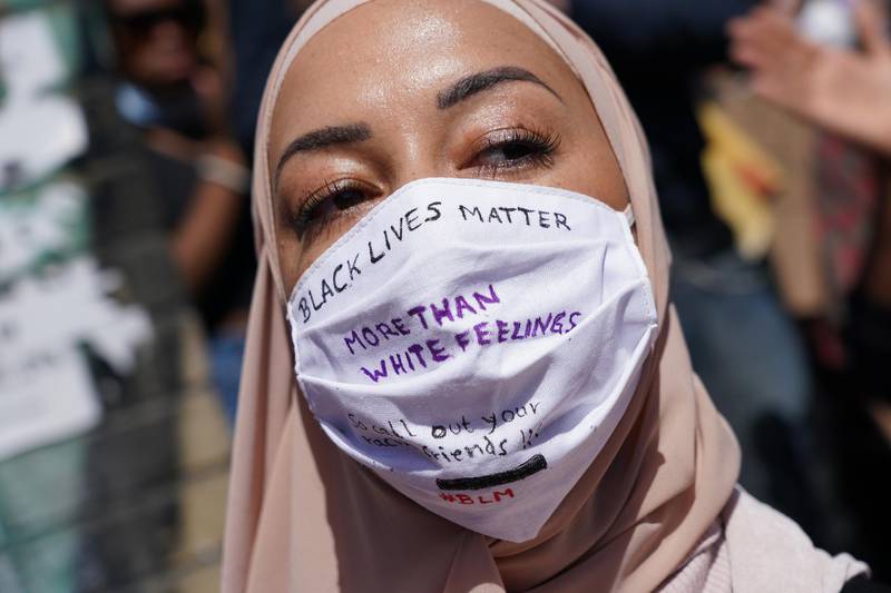 BERLIN, GERMANY  - MAY 31: A Muslim woman wears a face mask that reads: "Black lives matter more than white feelings" at a protest rally against racism following the recent death of George Floyd in the USA on May 31, 2020 in Berlin, Germany. The death of Floyd, an African-American man, at the hands of police in Minneapolis has struck a cord with many people of color who live in Germany. Demonstrators also gathered in front of the American Embassy in Berlin yesterday and today. (Photo by Sean Gallup/Getty Images)
