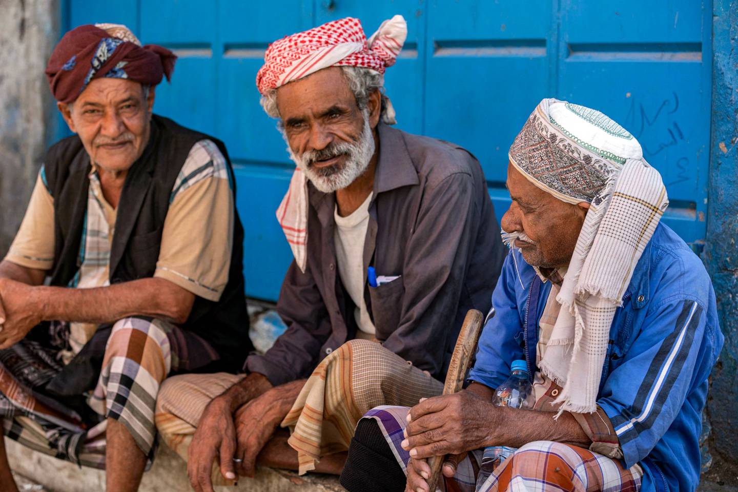 Men sit together in an open-air market in Yemen's third city of Taez. Reopening roads and other transport links to the city have been a major issue in negotiations. AFP
