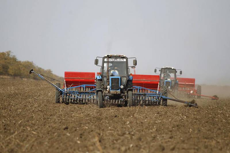 Tractors are used to sow winter wheat in a field in southern Russia. Domestic appetite for grain has been supported by a Russian ban on most Western food imports in retaliation for the sanctions. Eduard Korniyenko / Reuters