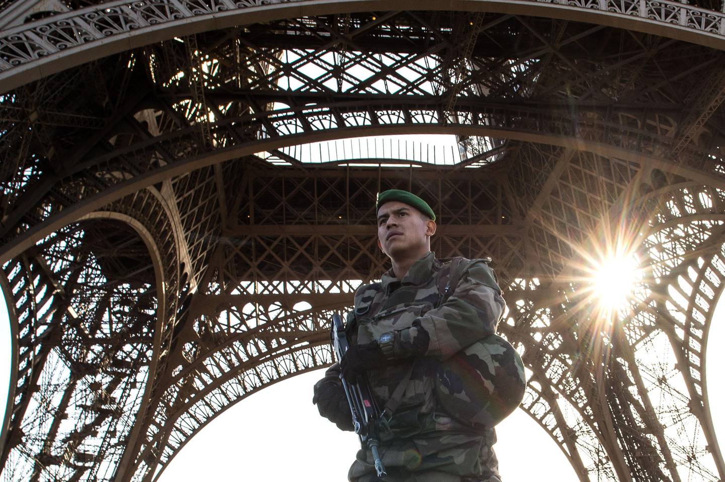 PARIS, FRANCE - NOVEMBER 15:  A French soldier stands guard at Eiffel Tower on November 15, 2015 in Paris, France. As France observes three days of national mourning members of the public continue to pay tribute to the victims of Friday's deadly attacks. A special service for the families of the victims and survivors is to be held at Paris's Notre Dame Cathedral later on Sunday.  (Photo by David Ramos/Getty Images)