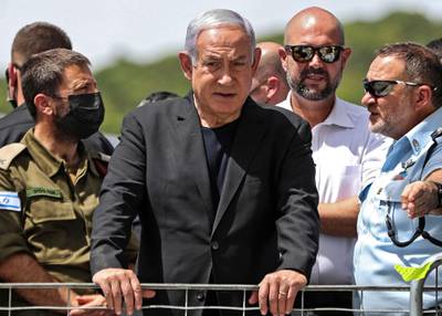 Israeli Prime Minister Benjamin Netanyahu, centre, visits the site of an overnight stampede during an ultra-Orthodox religious gathering in the northern Israeli town of Meron. AFP