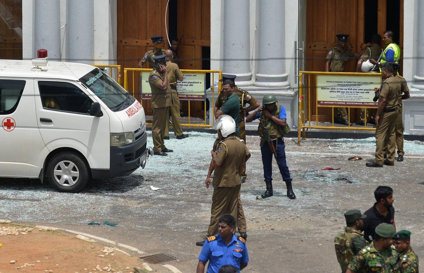 Sri Lankan security personnel stand next to an ambulance outside St. Anthony's Shrine in Kochchikade in Colombo on April 21, 2019 following a blast at the church.

 At least 42 people were killed April 21 in a string of blasts at hotels and churches in Sri Lanka as worshippers attended Easter services, a police official told AFP.
 / AFP / ISHARA S.  KODIKARA
