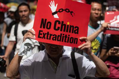 A protester marches with a placard during a rally against a controversial extradition law proposal in Hong Kong in 2019. AFP
